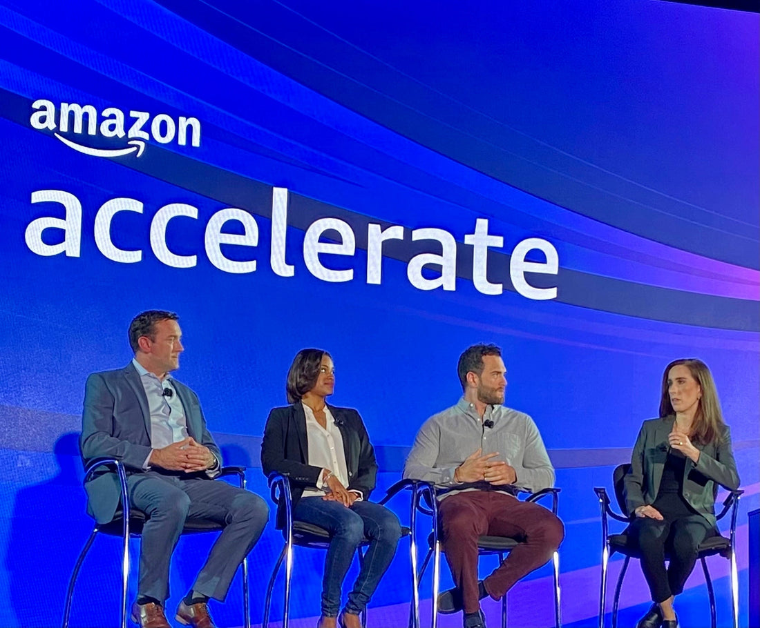Sean Brownlee on stage at Amazon Accelerate with Amazon Public Policy Senior Manager Erica McCann, Kennedy Lowery of Live By Being, and Colin McIntosh of Sheets & Giggles, panel backdrop displaying Amazon Accelerate.