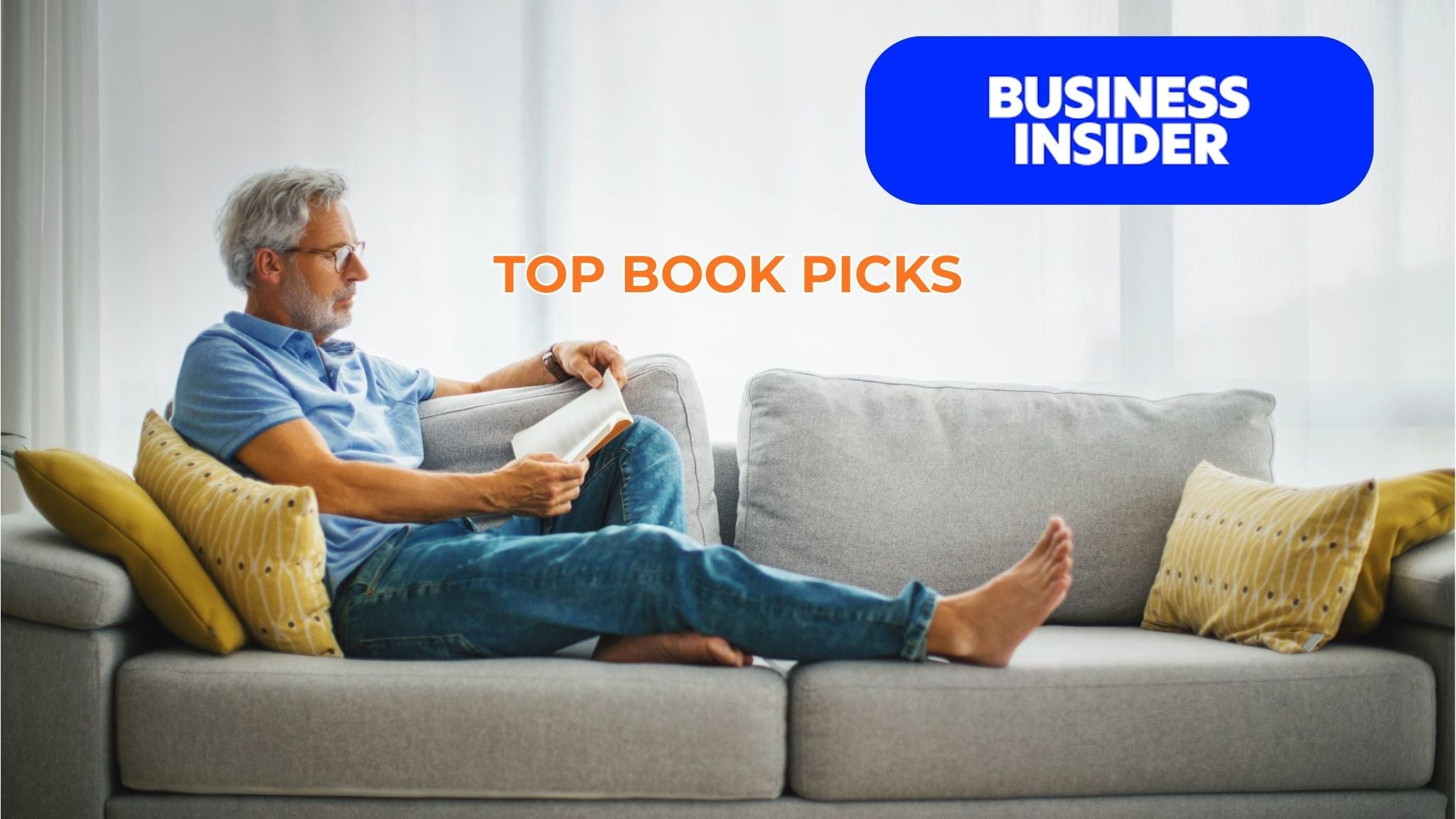 Mature man reading a book on the sofa, representing entrepreneurial learning and Sean Brownlee’s Business Insider–featured reading recommendations.