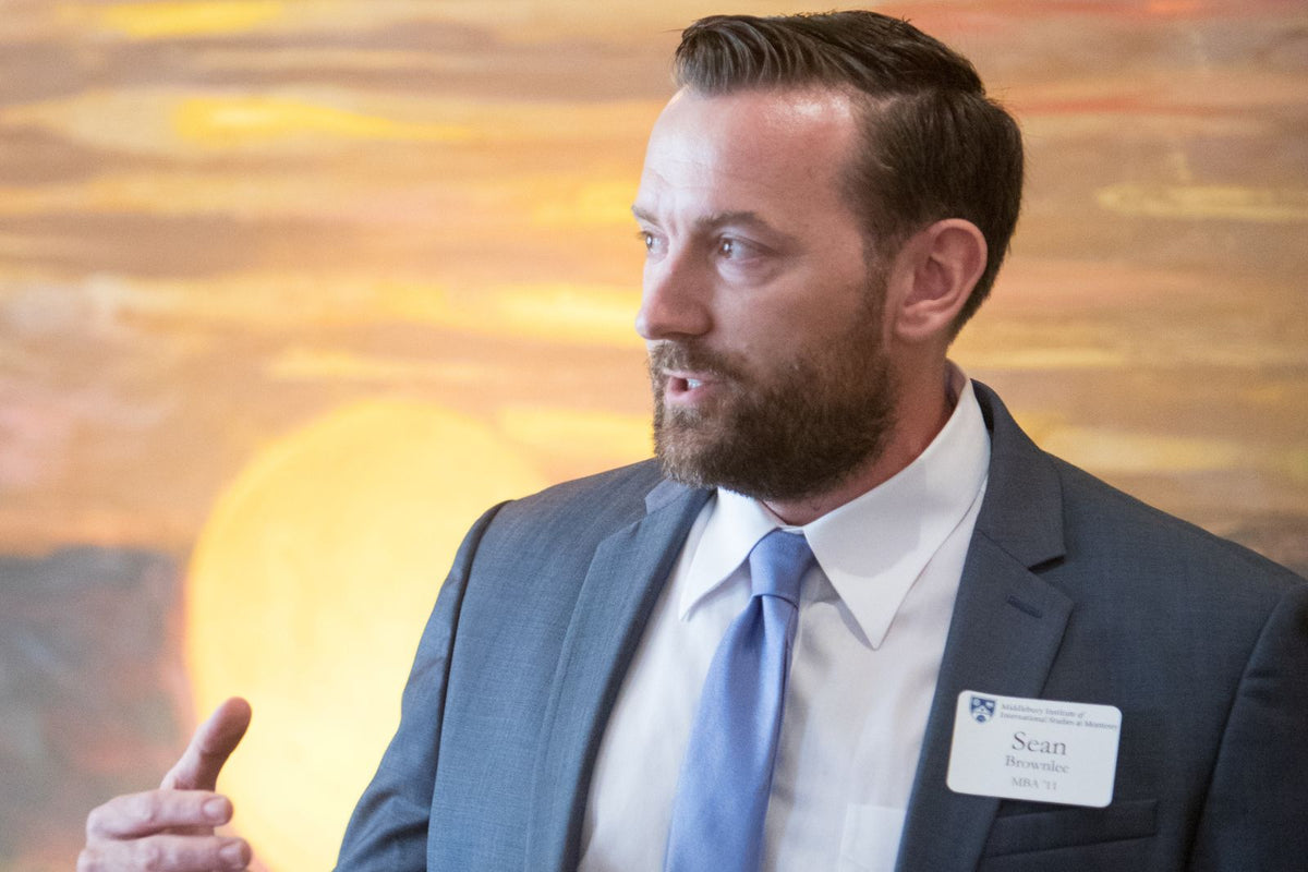 Sean Brownlee speaking with attendees at a professional event